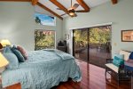 The master bedroom is spacious with a king bed and deck access